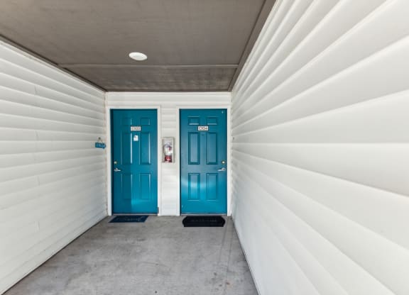 two blue doors at the end of a white garage door