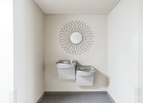 a bathroom with two toilets and a mirror on the wall