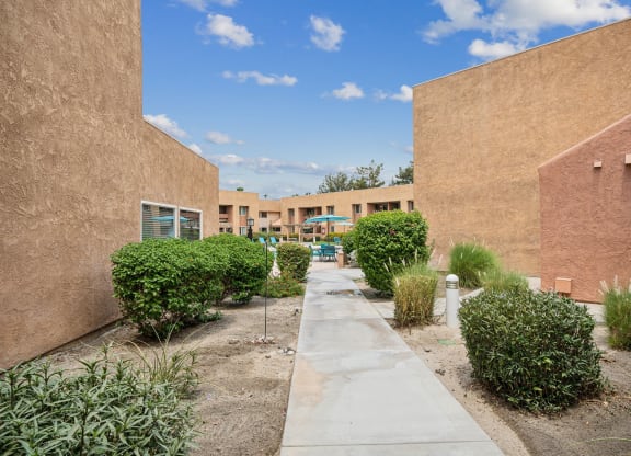 a walkway between two buildings in a courtyard