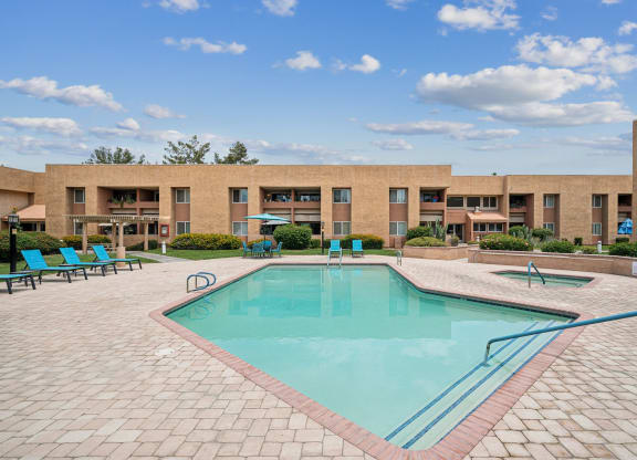 a swimming pool with a building in the background