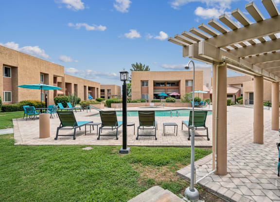 our apartments have a large patio with a pool and chairs