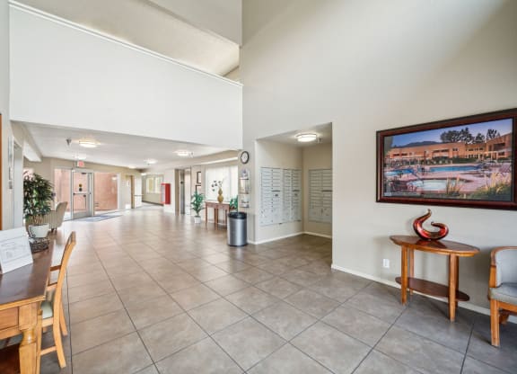 the lobby of a condo with a table and chairs