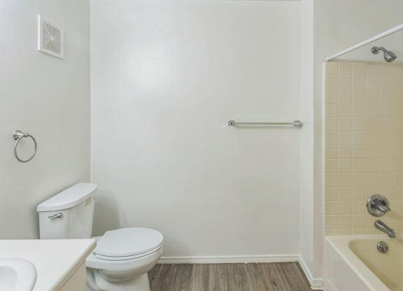 a bathroom with a toilet and a shower and a sink