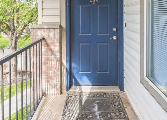 the front door of a house with a blue door