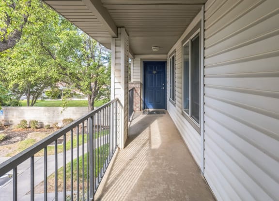 the view from the front porch of a house with a blue door