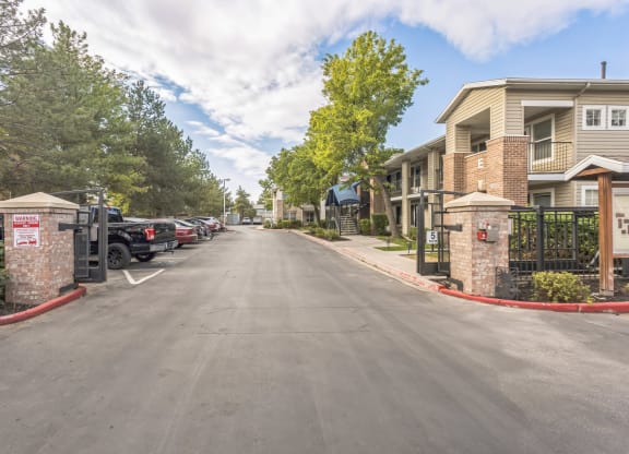 the enclave apartments exterior street view with cars parked on the side of the road