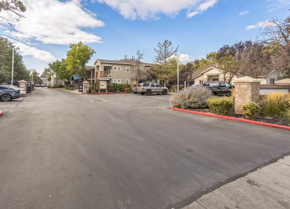 the view of a parking lot with houses on the side of the street