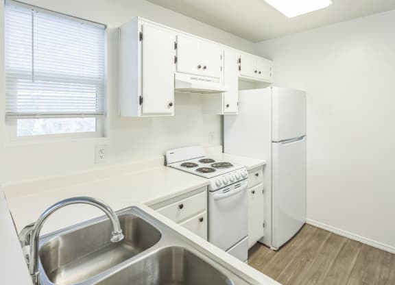 a kitchen with white appliances and white cabinets