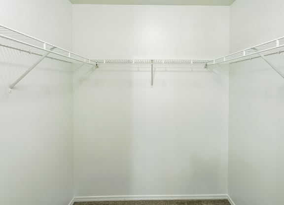 an empty room with white walls and a white closet