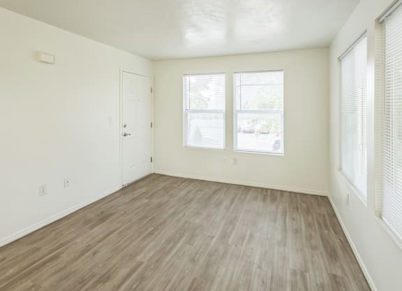 an empty room with a large window and a floor with a patterned flooring
