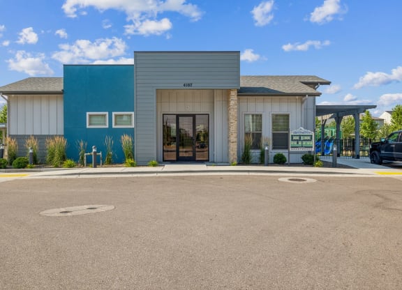 the front of a building with a parking lot