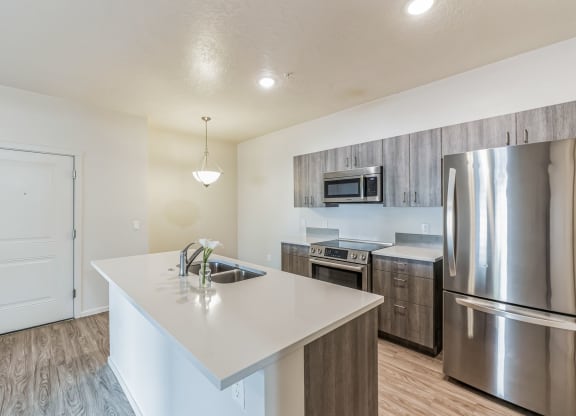 a kitchen with stainless steel appliances and a white counter top