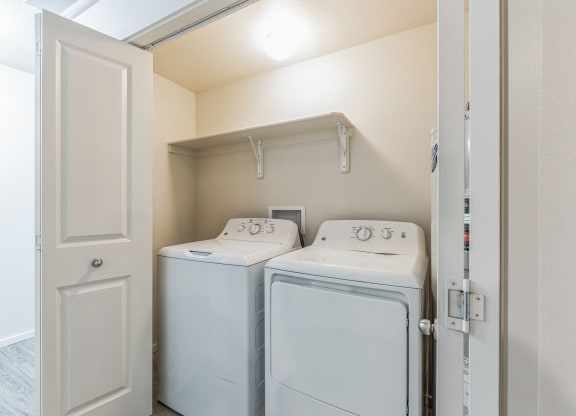 A small laundry room with a washer and dryer.