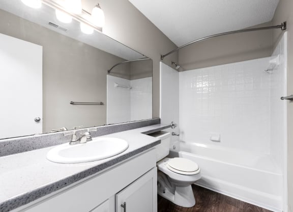 a bathroom with a sink toilet and a bath tub