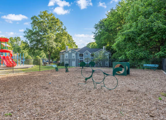 a park with a playground and a house in the background