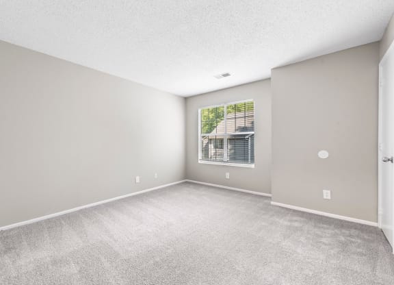 an empty living room with a large window