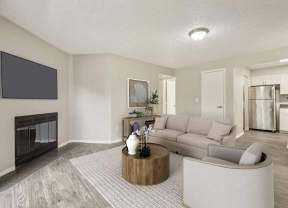A modern living room with a fireplace and a grey sofa.