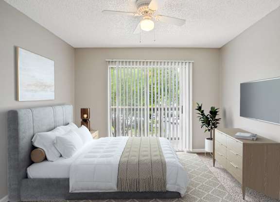 A bedroom with a large bed, a television, and a window with blinds.