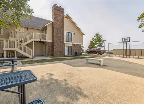 our apartments have an empty parking lot with a picnic table