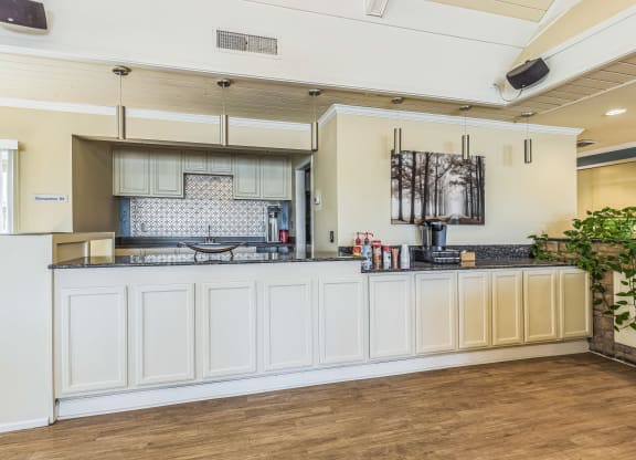 a kitchen with white cabinets and a counter top