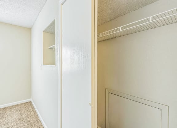 a bedroom with a closet and a door to a closet