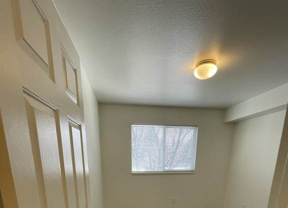 A small room with a door and a window.