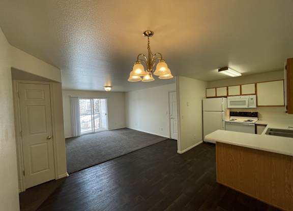 A kitchen with a white counter top and a microwave.