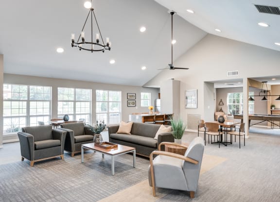 a living room with couches and chairs and a dining room with a table