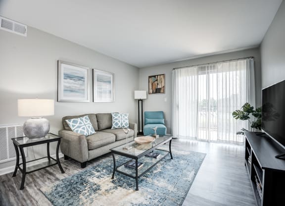 our apartments offer a living room with a couch and a tv