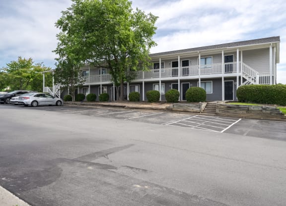 an empty parking lot in front of an apartment building