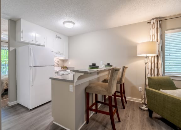 a kitchen with a breakfast bar and a white refrigerator