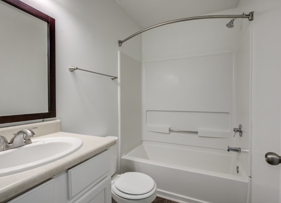 a bathroom with a sink toilet and a bath tub