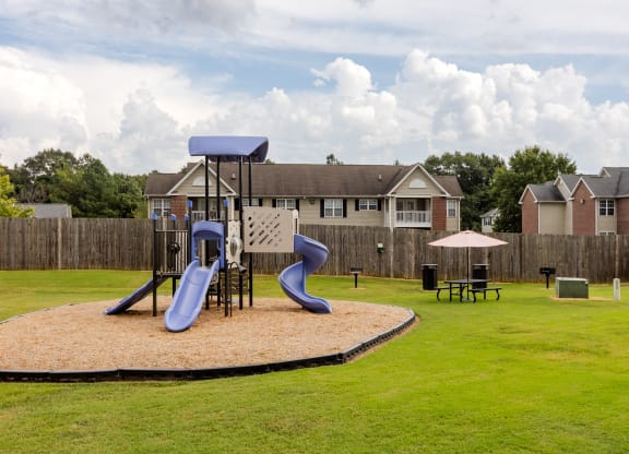 our apartments have a playground with slides and a picnic table