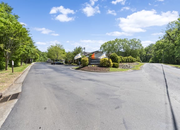 an empty street with a house on the corner of a road