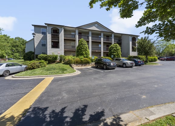 an apartment building with cars parked in front of it