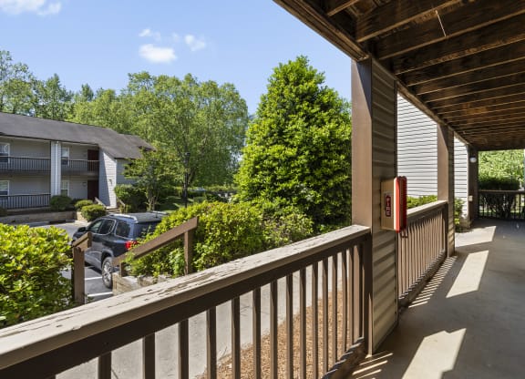 the view of the street from the front porch of a house