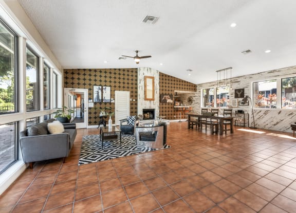 a living room with a fireplace and a table and chairs