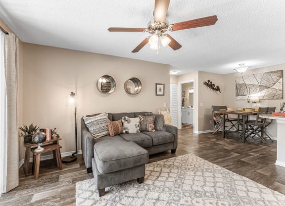 a living room with a couch and a ceiling fan