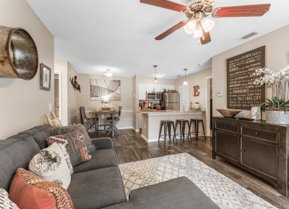 a living room with a couch and a kitchen in the background