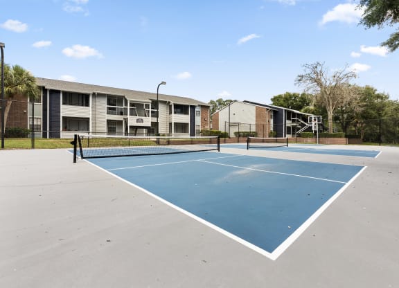 the tennis courts at the whispering winds apartments in pearland tx