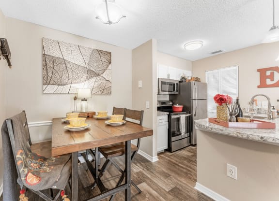 an open kitchen and dining room with a table and chairs