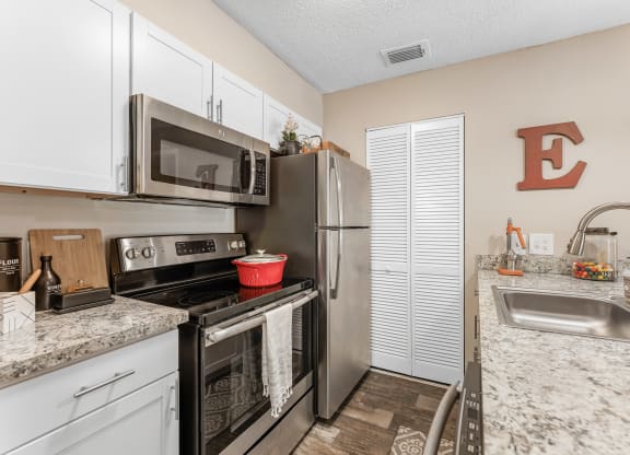 a kitchen with stainless steel appliances and granite counter tops