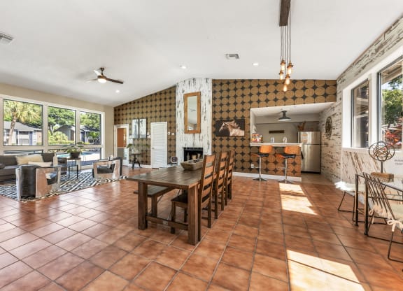 a living room and dining room with a table and chairs
