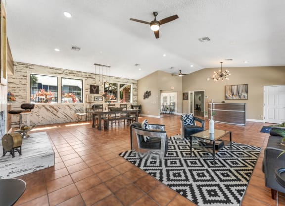 the living room and dining area of a house with a stone wall
