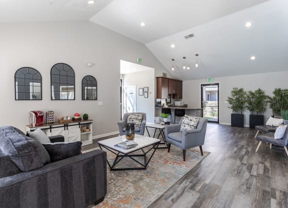 a living room with couches and chairs and a table