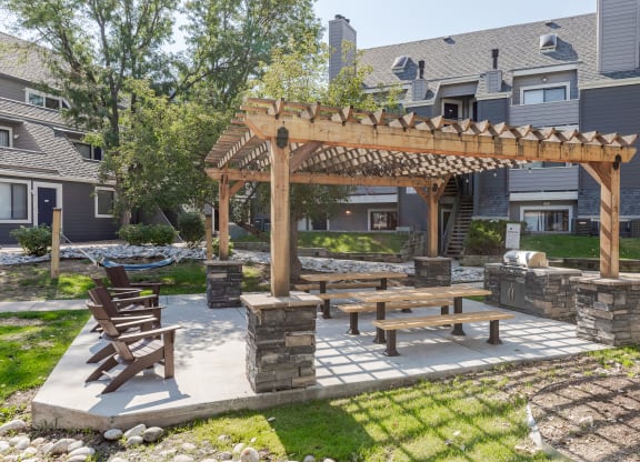 an outdoor patio with a picnic table and a pergola