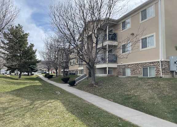 Apartment building with a walkway in front of it.