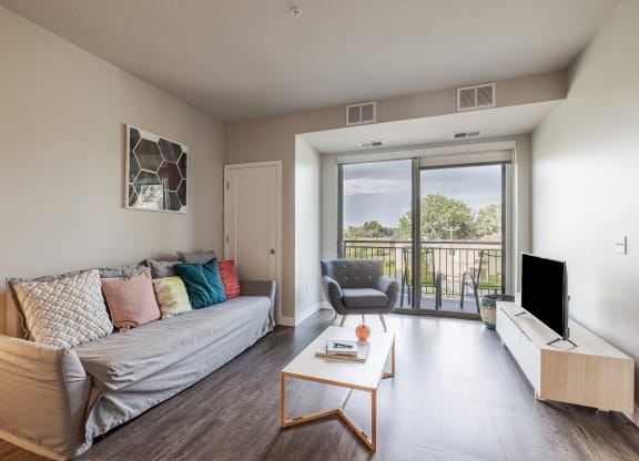 an open living room with a couch and a television