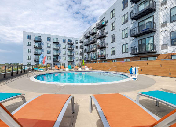 an apartment swimming pool in front of an apartment building