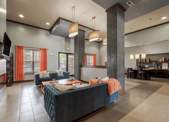 the lobby of a clubhouse with couches and a table